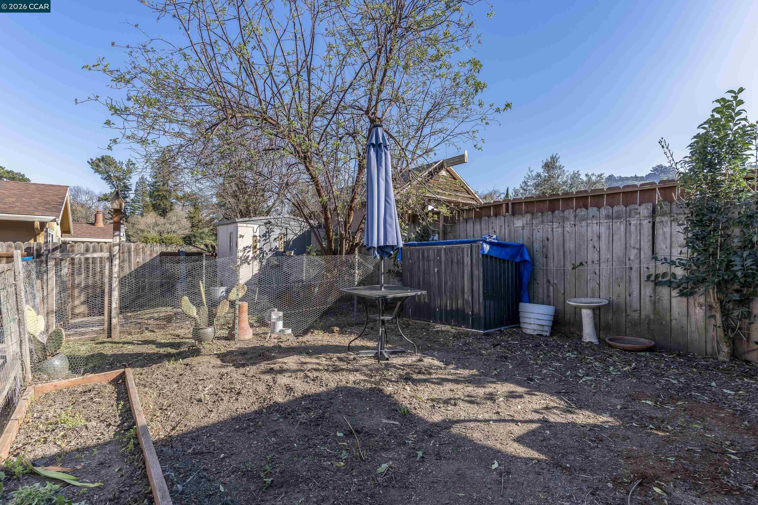 2312 Granada Court Pinole, CA 94564 - Photo 52 of 60 a view of a backyard with wooden fence and a large tree