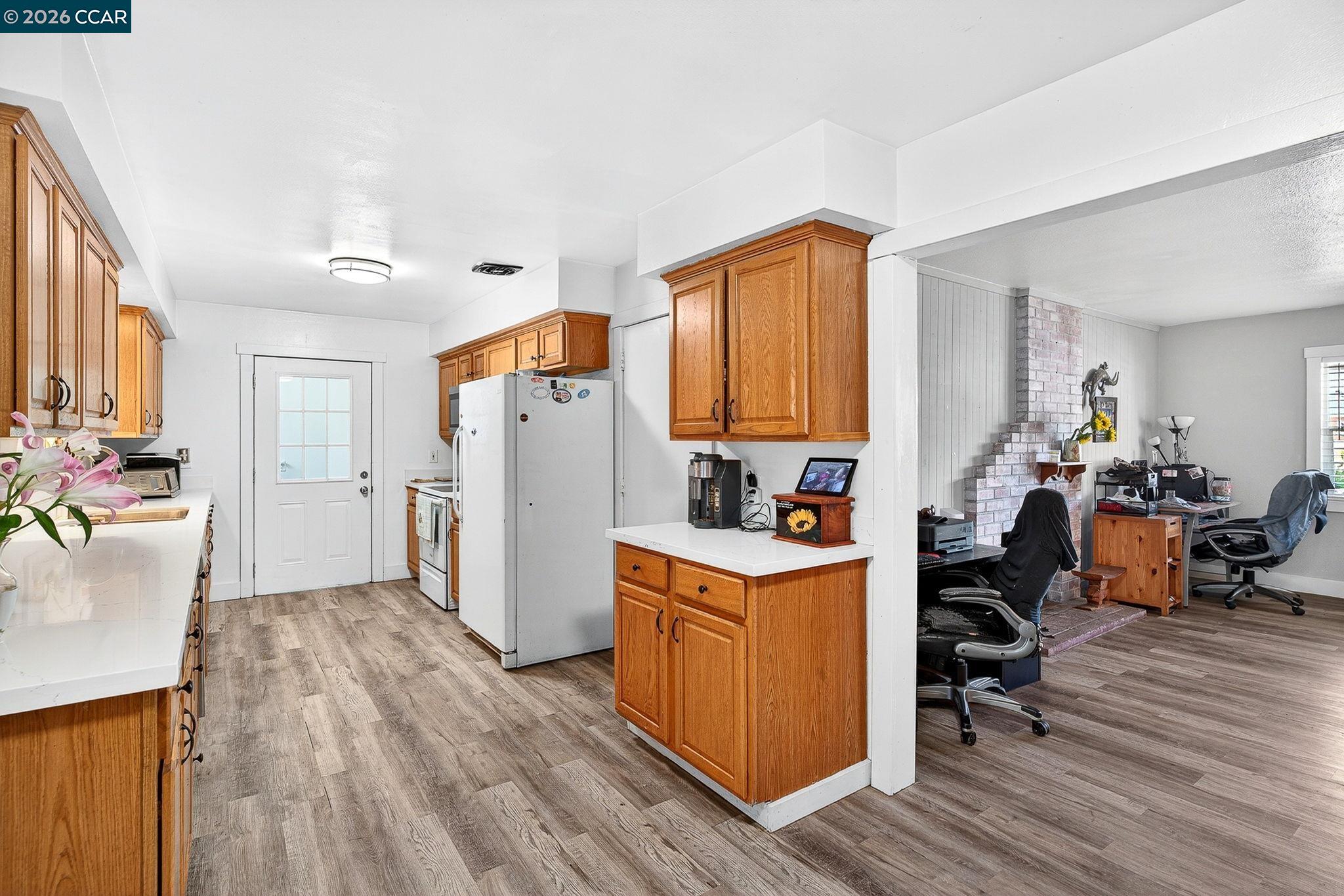 2312 Granada Court Pinole, CA 94564 - Photo 10 of 60 a view of a kitchen with refrigerator and wooden floor