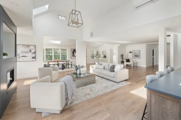 a living room with furniture and a chandelier