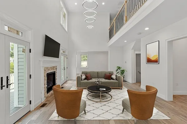 a living room with a couch a flat screen tv and a fireplace