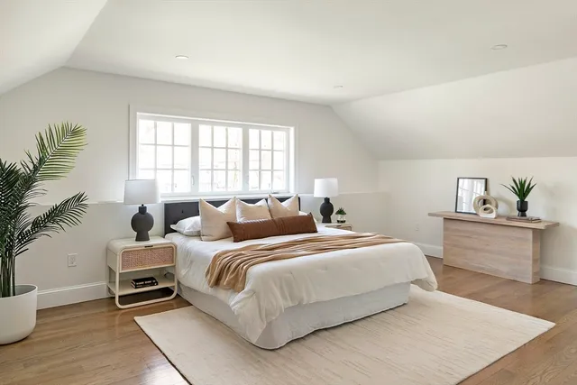 a bedroom with a bed and a potted plant