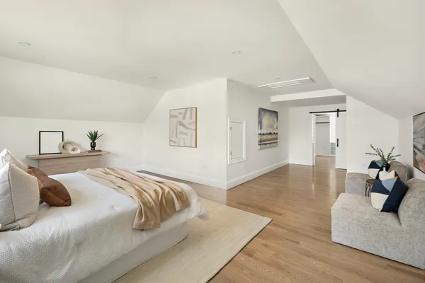 a bedroom with a bed and couch