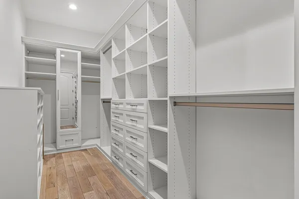 a view of walk in closet with empty racks