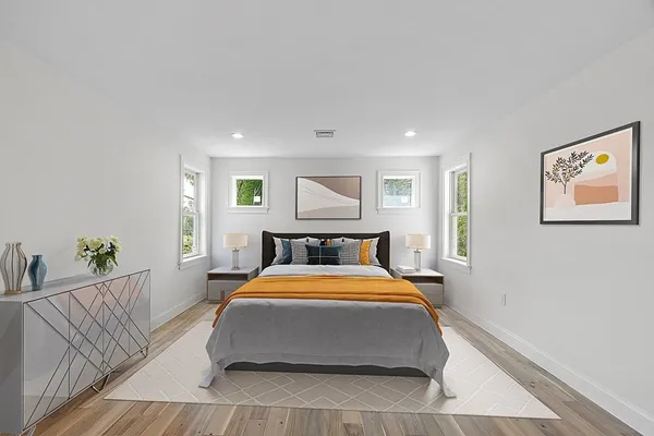 a bedroom with a large bed and a chandelier