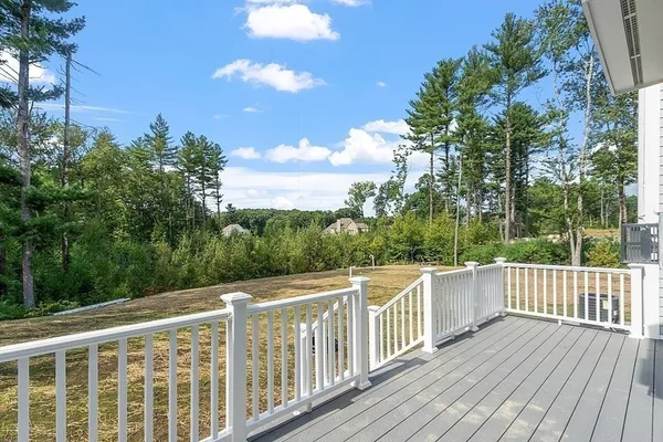 a view of a balcony with wooden floor and fence