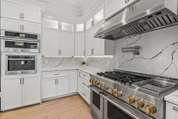 a kitchen with stainless steel appliances granite countertop a stove and a sink