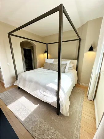 a bedroom with a bed next to a window