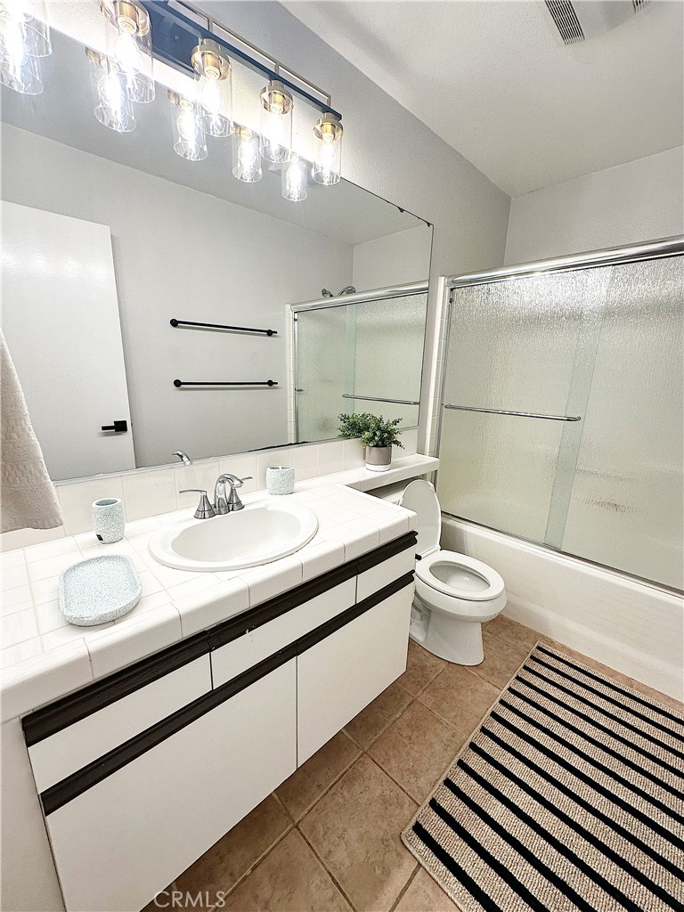 28474 Porsena Way Trabuco Canyon, CA 92679 - Photo 6 of 8 a bathroom with a granite countertop sink toilet and shower