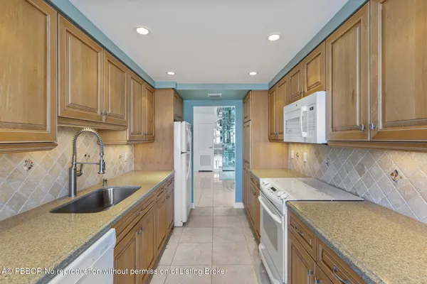 a kitchen with a sink a stove and cabinets