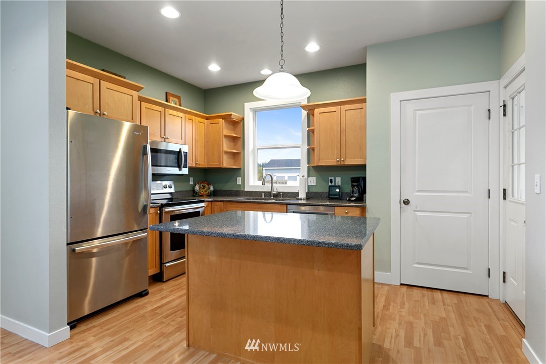 106 Ridgeview Street Sumas, WA 98295 - Photo 20 of 31 a kitchen with granite countertop a refrigerator a sink and wooden floor