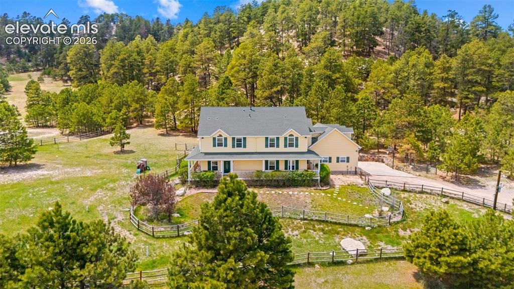 16540 Mesquite Road Peyton, CO 80831 - Photo 45 of 50 a view of a swimming pool with lawn chairs and plants