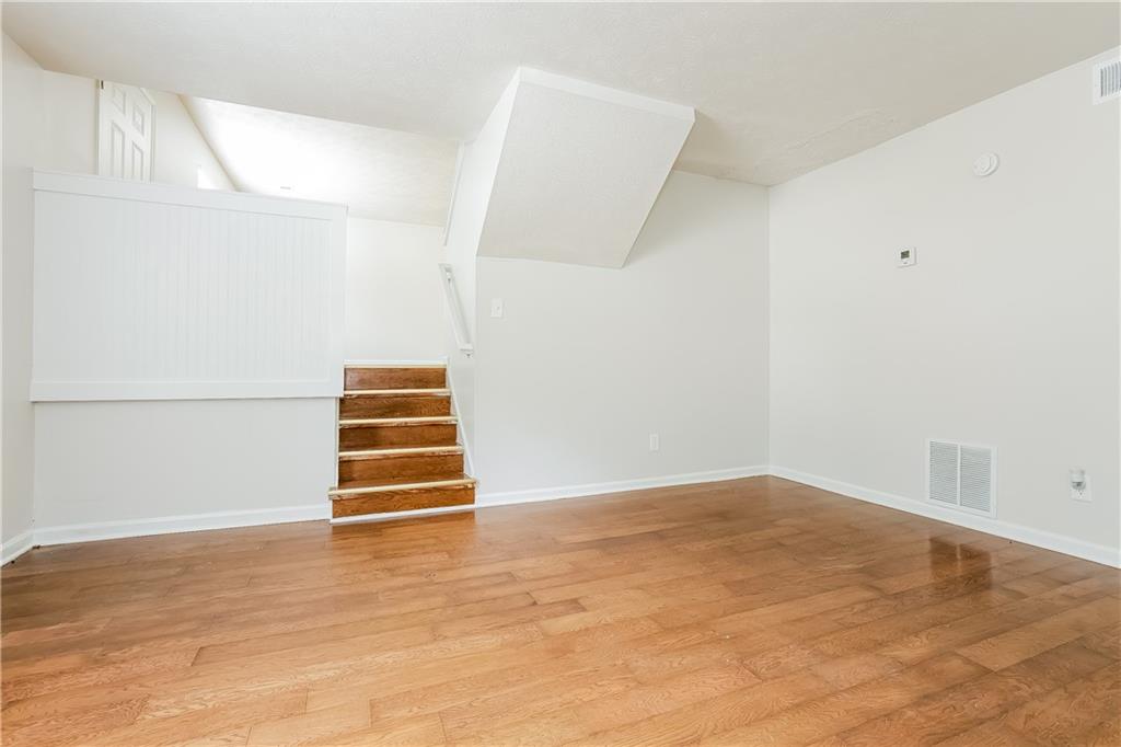 3352 Herrenhut Road Lithonia, GA 30038 - Photo 11 of 27 a view of room with stairs and wooden floor