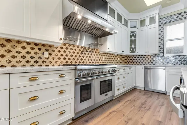 a kitchen with granite countertop white cabinets and white appliances