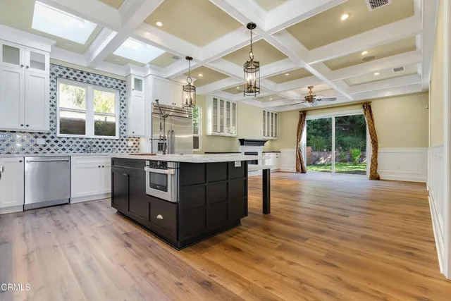 a kitchen with stainless steel appliances granite countertop a stove oven and a refrigerator