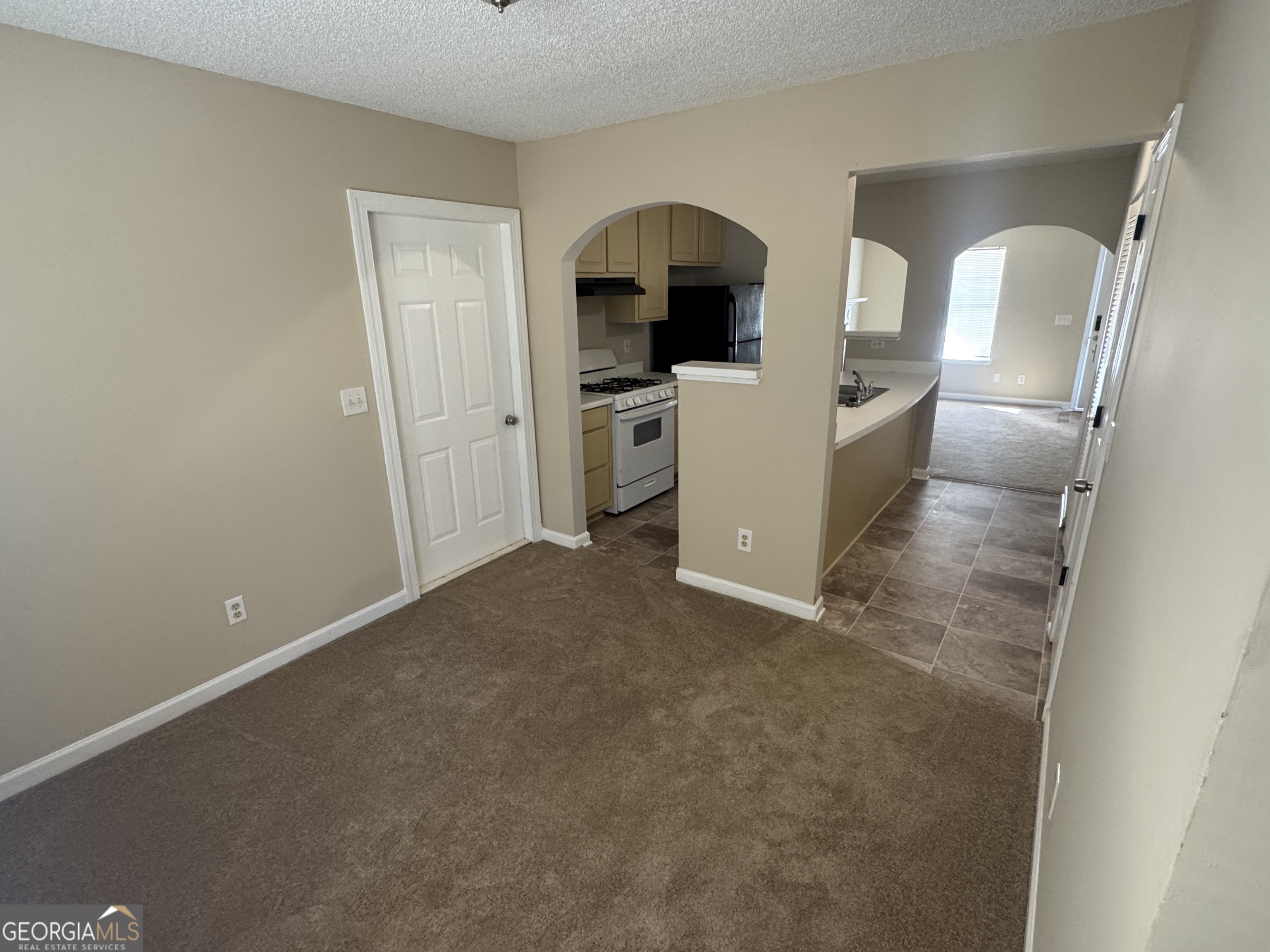 116 Pointe Court Griffin, GA 30224 - Photo 12 of 17 a view of a kitchen with fridge and wooden floor