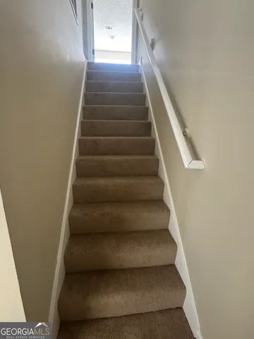 an empty room with closet and a bathroom