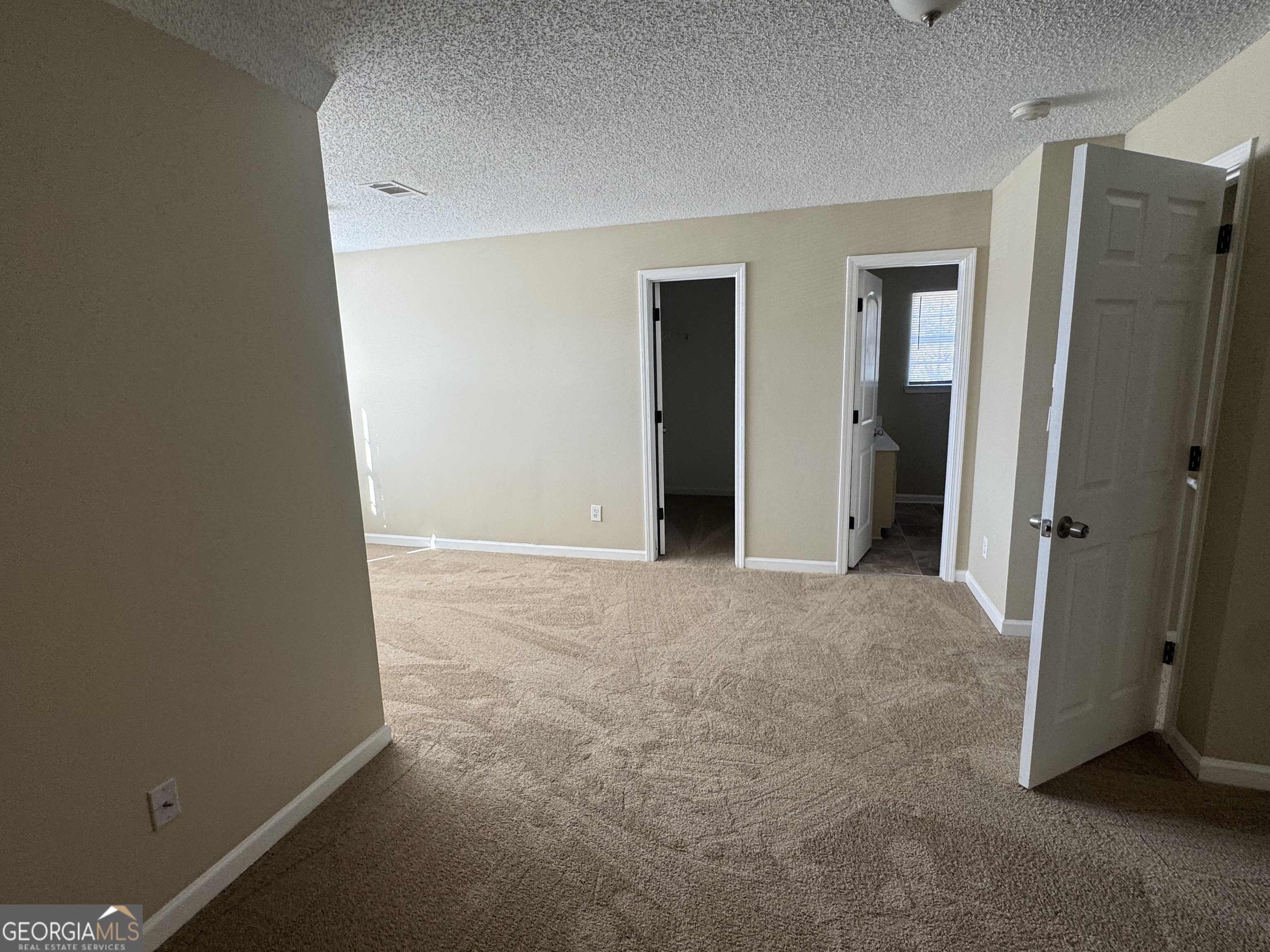116 Pointe Court Griffin, GA 30224 - Photo 7 of 17 an empty room with closet and a bathroom