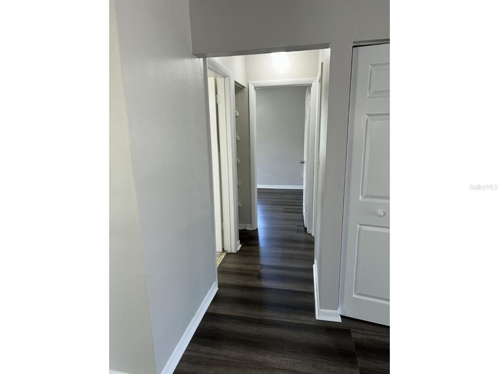 1241 Pilgrim Road Spring Hill, FL 34606 - Photo 15 of 28 a view of a hallway with wooden floor