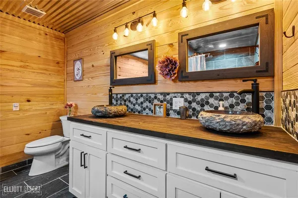 a bathroom with a sink a toilet and mirror