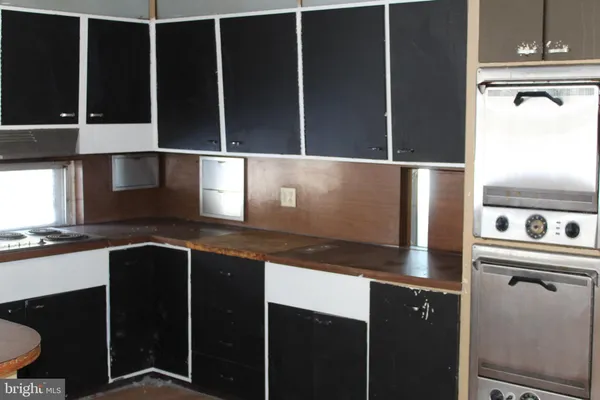 a kitchen with granite countertop a refrigerator and a sink