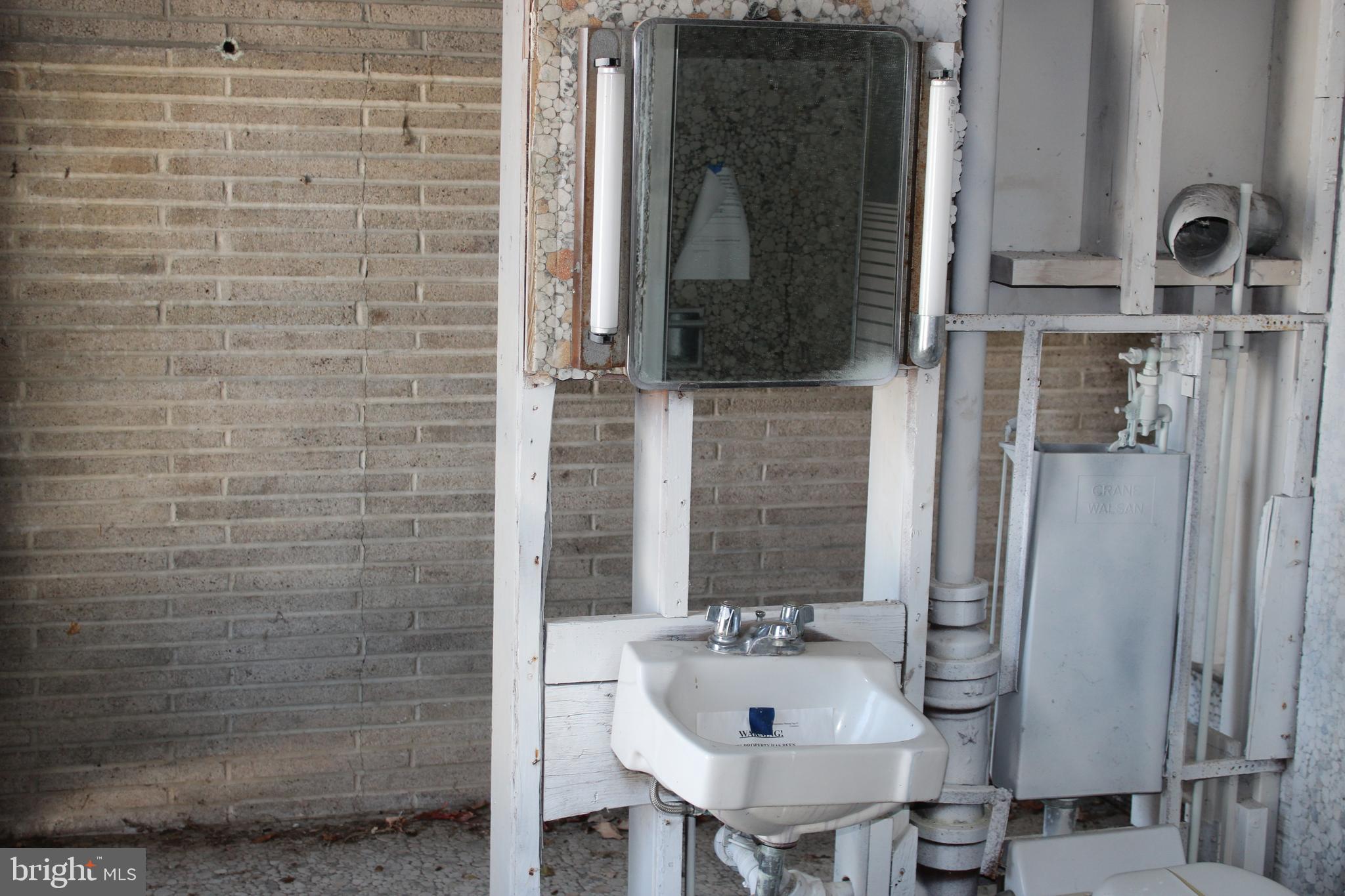 1048 Upper River Road Ewing, NJ 08628 - Photo 5 of 14 a bathroom with a sink and a mirror