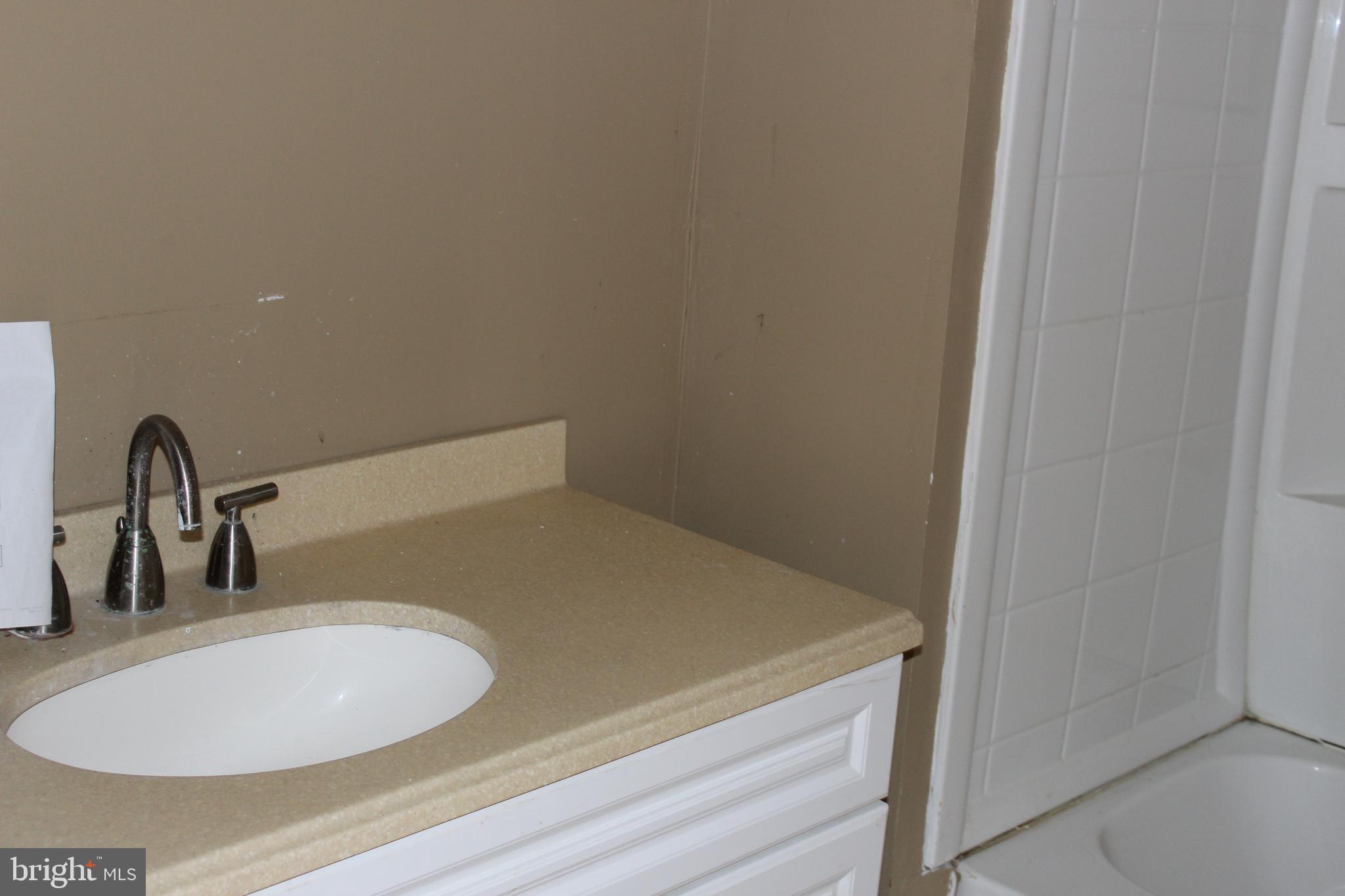 1048 Upper River Road Ewing, NJ 08628 - Photo 7 of 14 a bathroom with a sink and a mirror