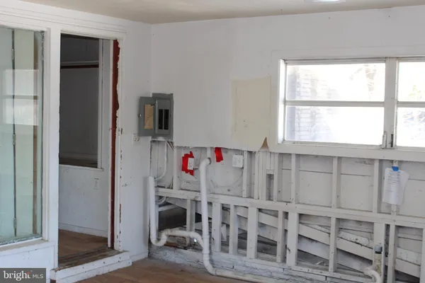 a utility room with multiple racks and windows