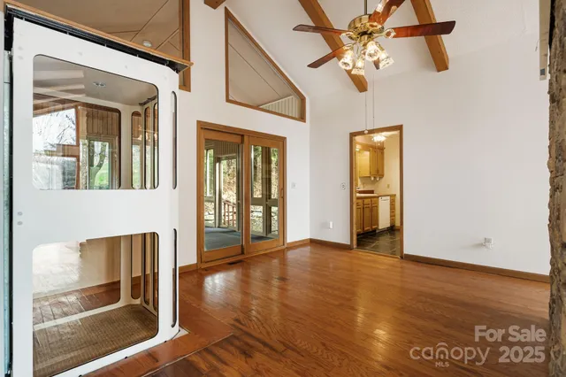 a view of an entryway with wooden floor