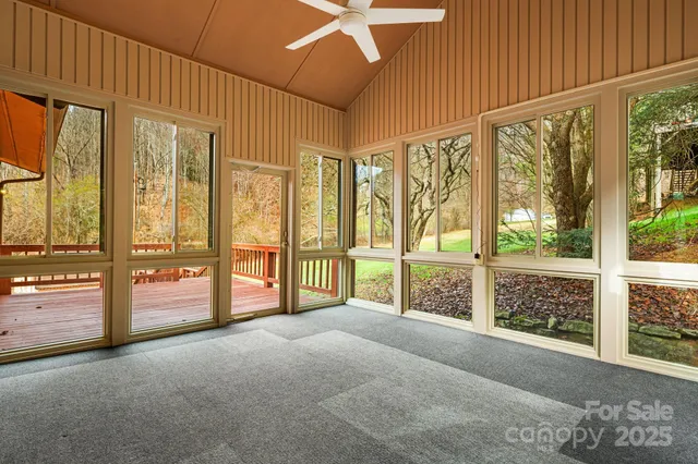 a view of an empty room with large windows