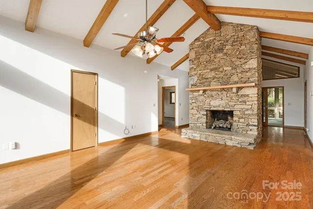 a view of a livingroom with a fireplace and chandelier