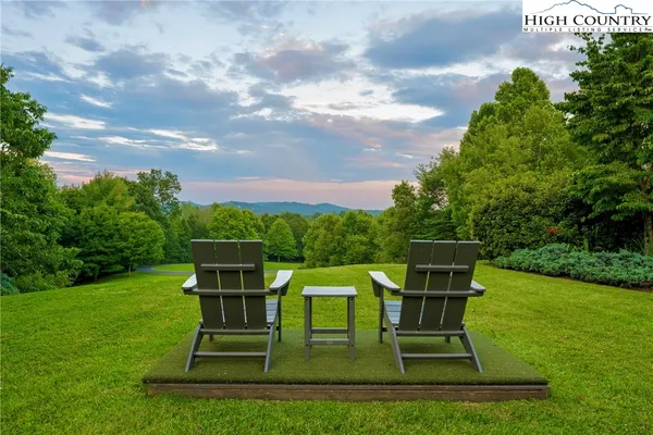 a view of a chairs in a backyard
