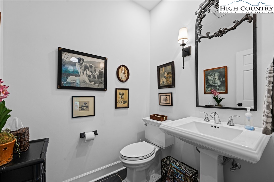 1920 Deck Hill Road Blowing Rock, NC 28605 - Photo 28 of 50 a bathroom with a toilet a sink and a mirror