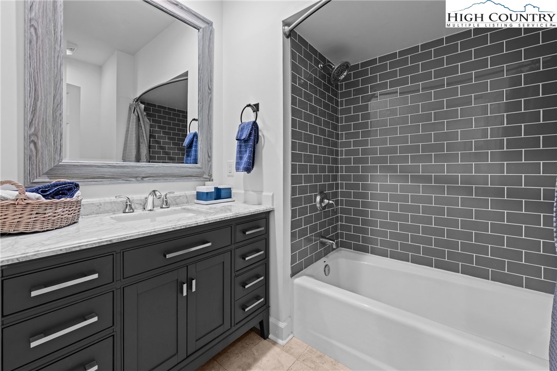 1920 Deck Hill Road Blowing Rock, NC 28605 - Photo 31 of 50 a bathroom with a granite countertop bathtub sink vanity and mirror