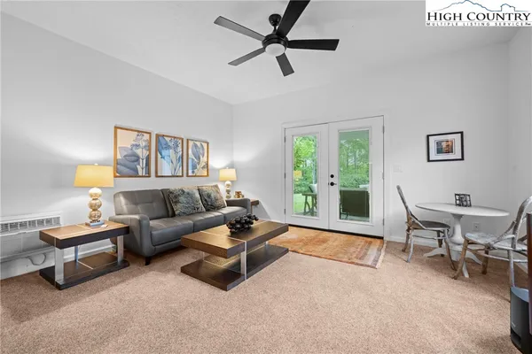 a livingroom with furniture staircase and a window