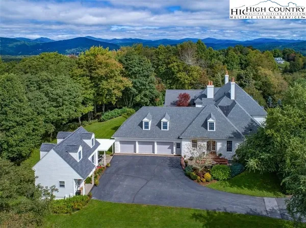 an aerial view of a house with a garden and swimming pool