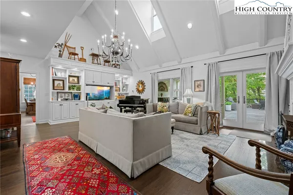 a kitchen with stainless steel appliances granite countertop a stove a sink dishwasher and a refrigerator with wooden floor