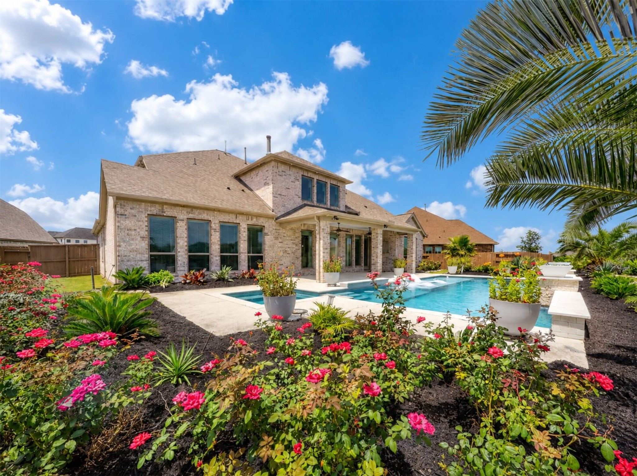 4343 Martin Ridge Drive Manvel, TX 77578 - Photo 42 of 50 a front view of a house with a big yard and potted plants