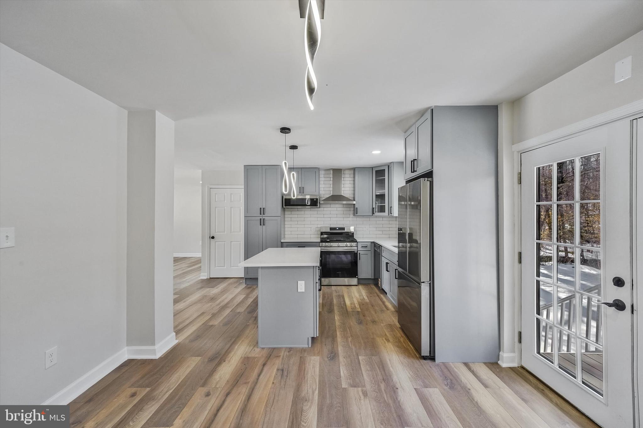 3629 Parklane Road Fairfax, VA 22030 - Photo 12 of 45 a view of a kitchen with kitchen island wooden floors stainless steel appliances and cabinets