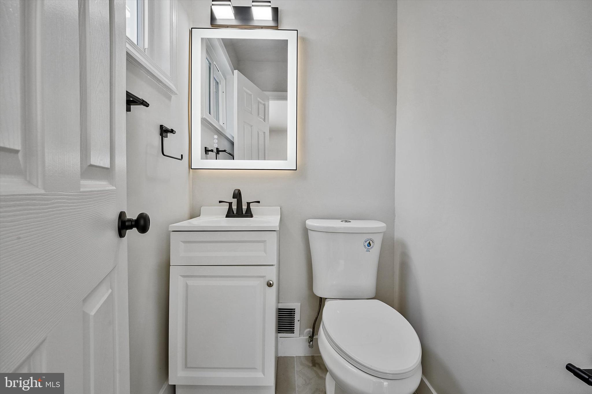 3629 Parklane Road Fairfax, VA 22030 - Photo 29 of 45 a white toilet sitting next to a bathroom sink