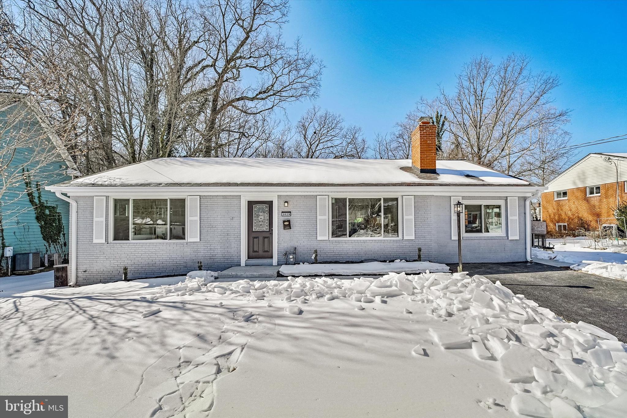 3629 Parklane Road Fairfax, VA 22030 - Photo 4 of 45 a front view of a house with a yard covered in snow