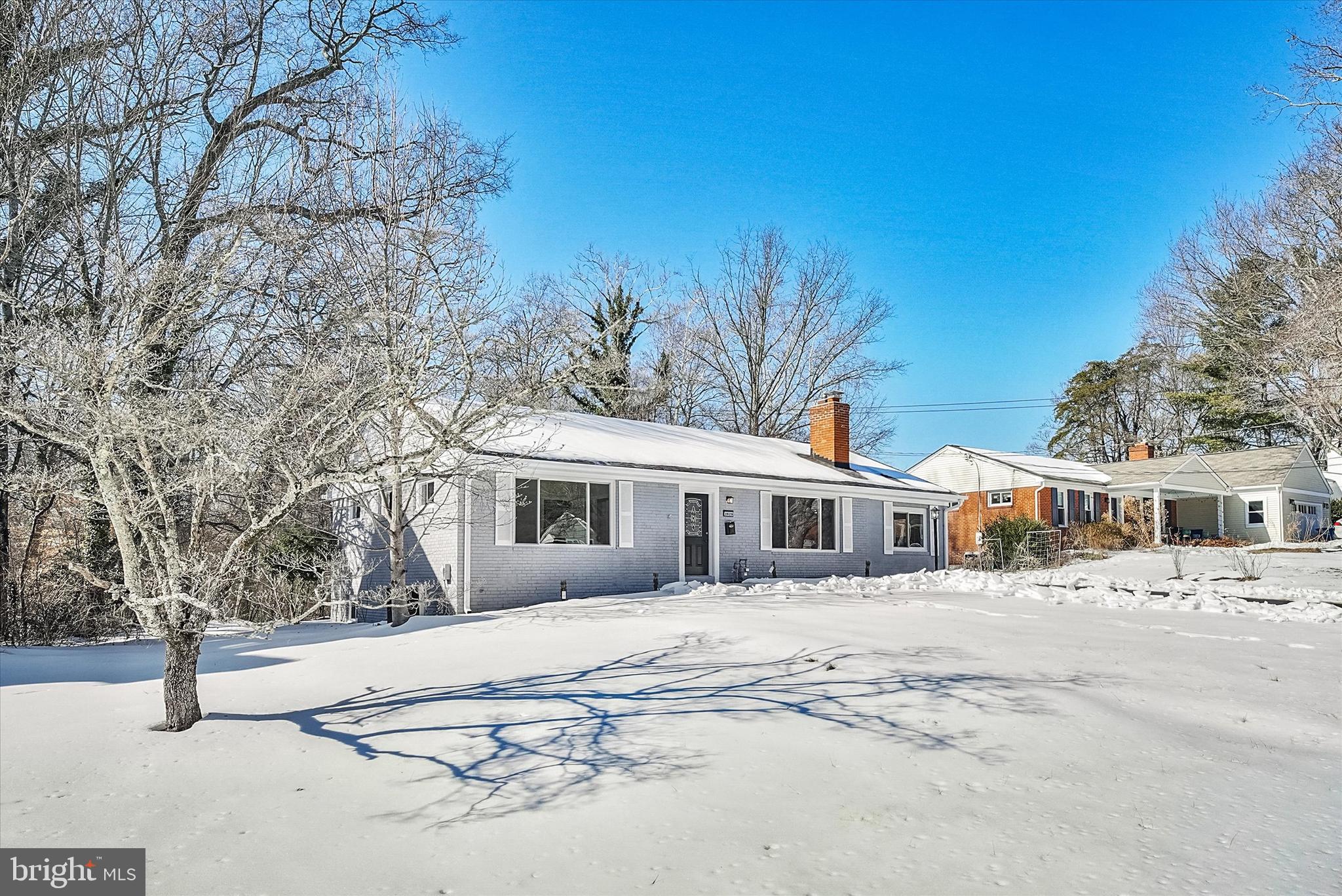 3629 Parklane Road Fairfax, VA 22030 - Photo 5 of 45 a view of a white house with a yard covered in snow