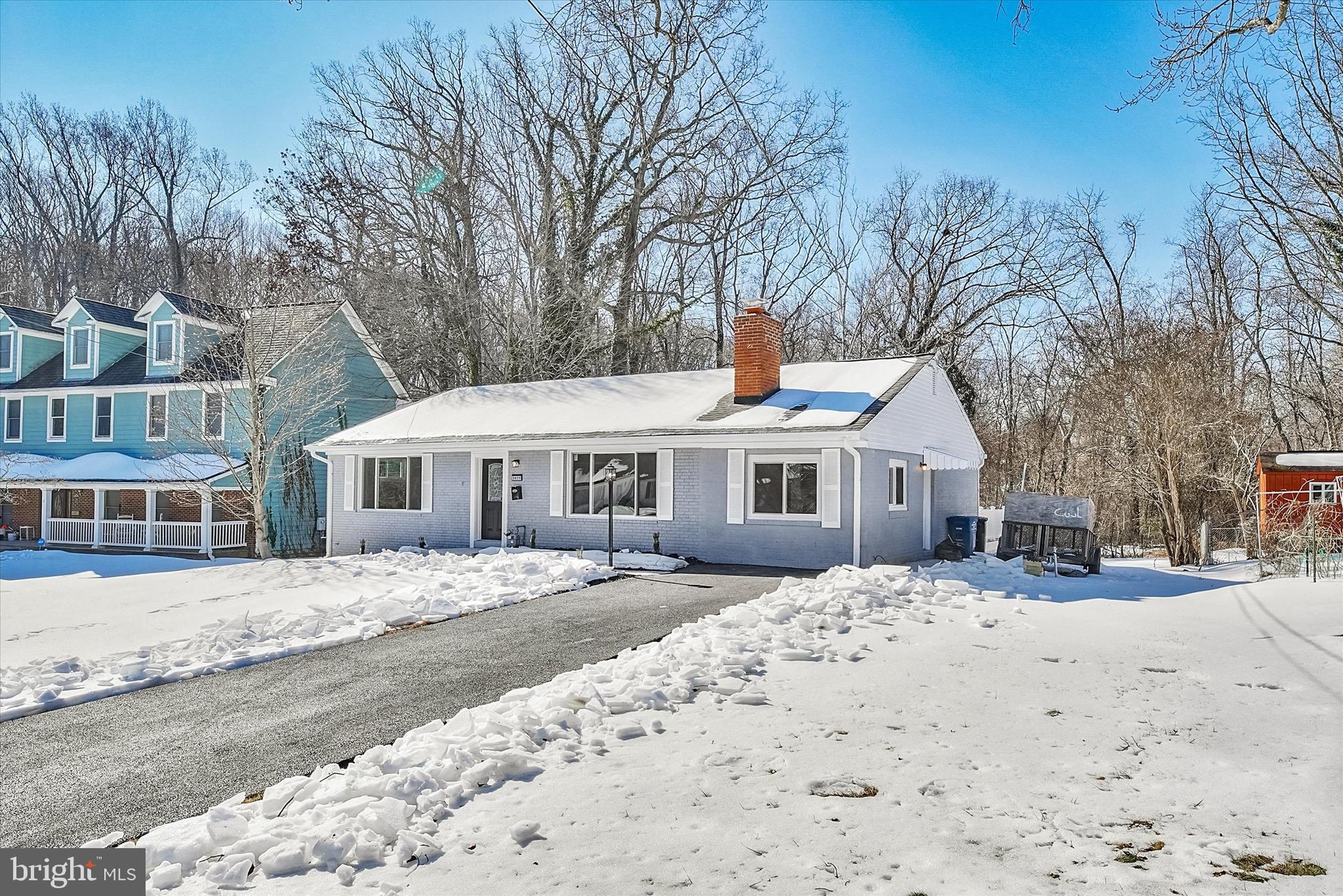 3629 Parklane Road Fairfax, VA 22030 - Photo 7 of 45 a front view of a house with a yard covered in snow