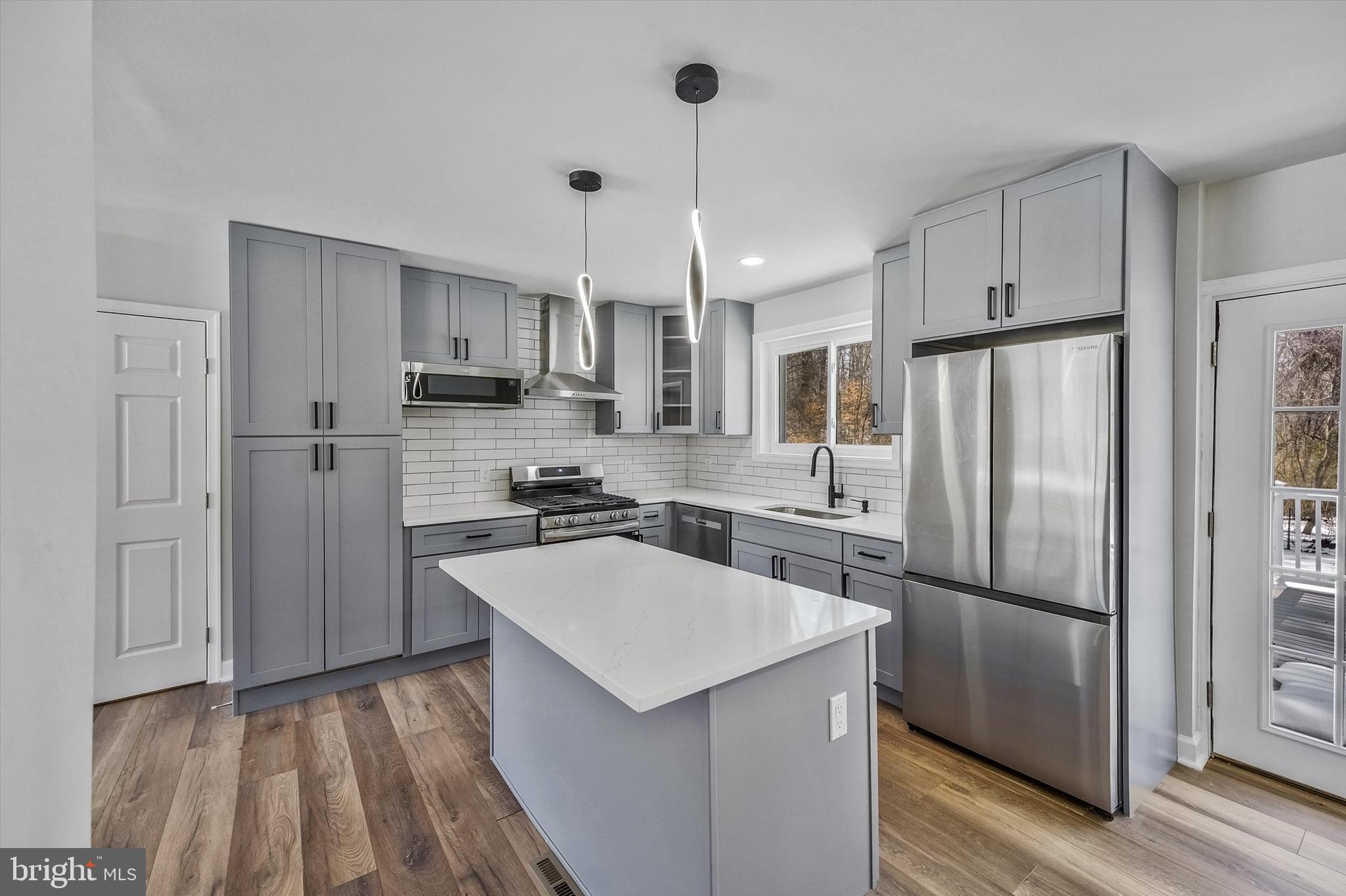 3629 Parklane Road Fairfax, VA 22030 - Photo 9 of 45 a kitchen with a refrigerator a sink and cabinets
