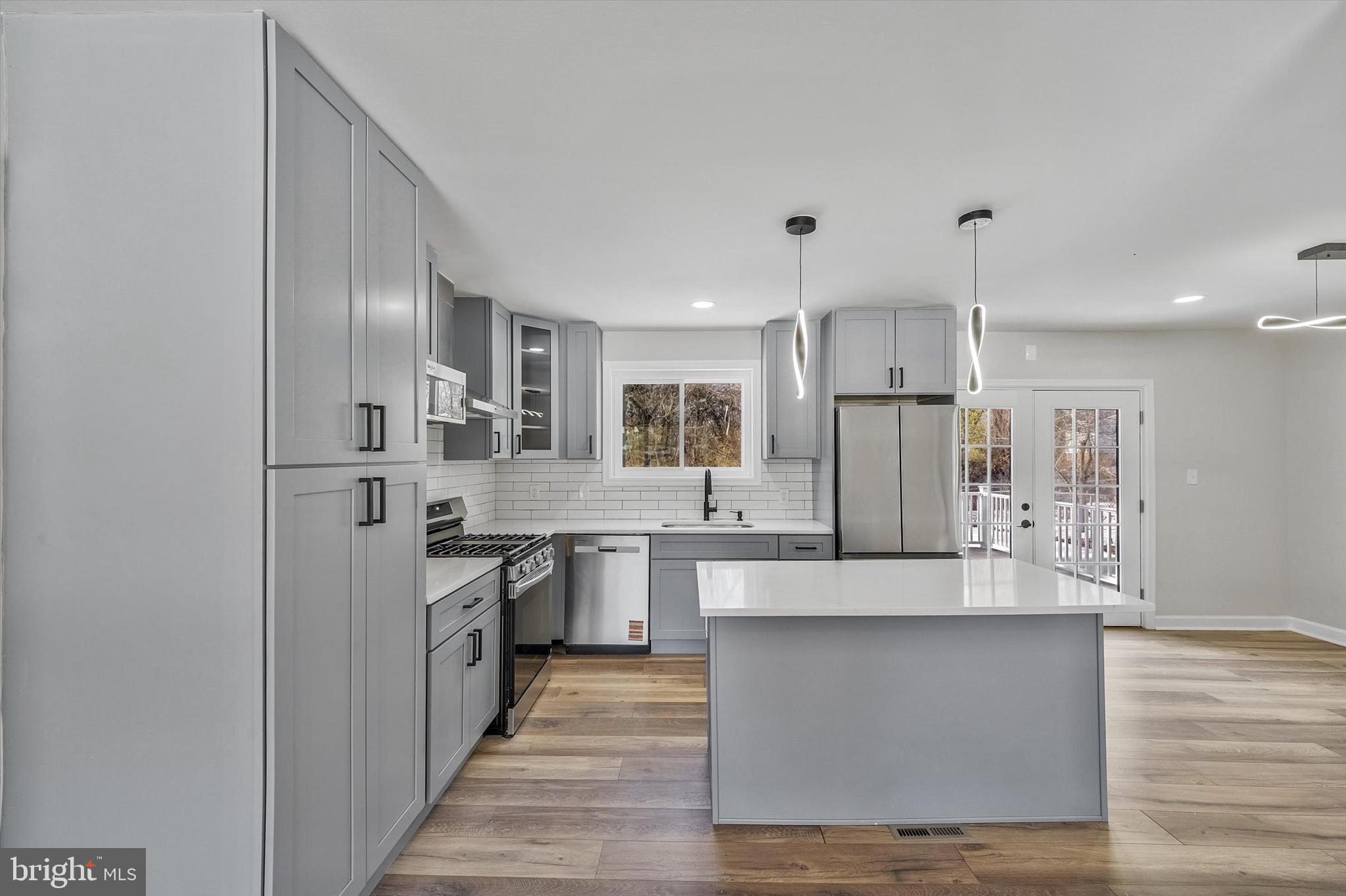 3629 Parklane Road Fairfax, VA 22030 - Photo 10 of 45 a large kitchen with stainless steel appliances kitchen island granite countertop a refrigerator and a stove top oven