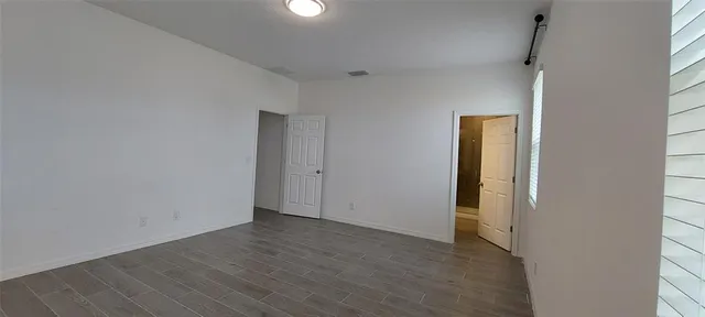 a bathroom with a granite countertop sink a toilet and shower
