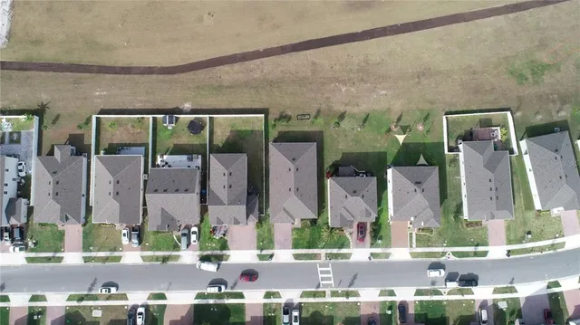 an aerial view of houses with yard