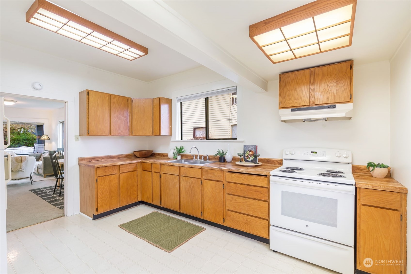 1122 26th Avenue Seattle, WA 98122 - Photo 6 of 17 a kitchen with a stove a sink and a microwave