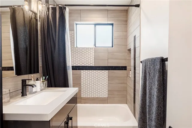 a bathroom with a sink a mirror and a bathtub