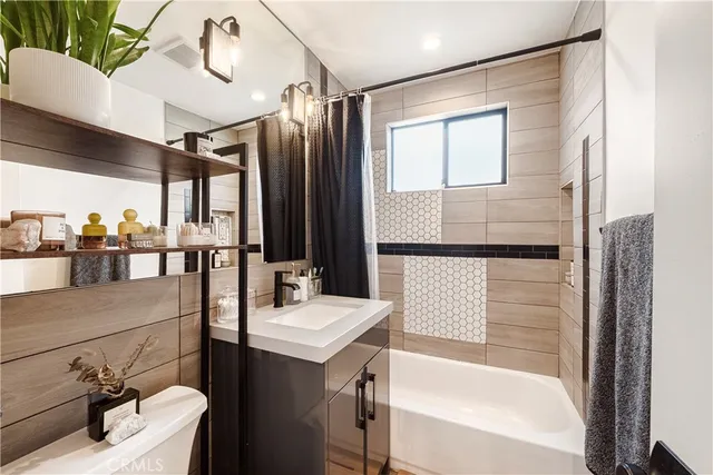 a bathroom with a bathtub a sink and mirror