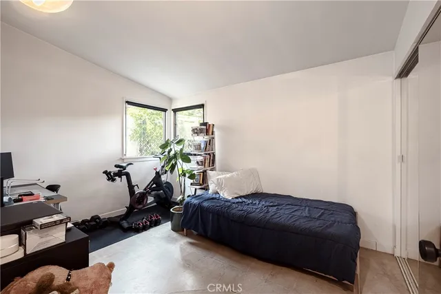 a bedroom with a bed couch and a window